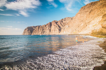 Amazing view of beach in Los Gigantes with high cliffs on the sunset. Location: Los Gigantes, Tenerife, Canary Islands. Artistic picture. Beauty world.