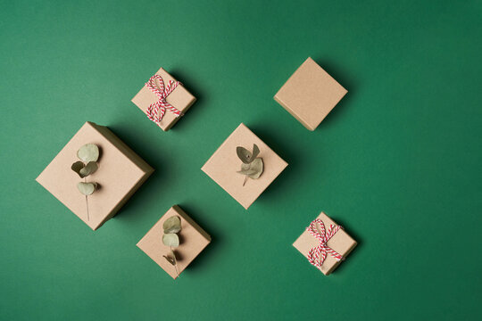 Flat Lay Boxes With Decoration Natural Red Rope And Green Dry Eucalyptus Leaves On Green Background. High Quality Photo