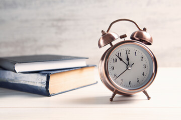 alarm clock with a book on the table
