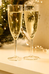 two glasses of champagne with white background and lights