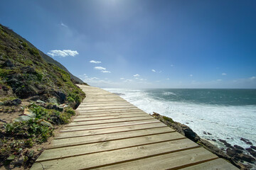 Low angle view of wooden footpath along hiking trail at Robberg Nature Reserve, Plettenberg Bay, South Africa.