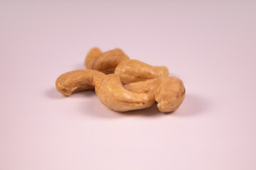 Small handful of peeled ripe cashew kernels on white background