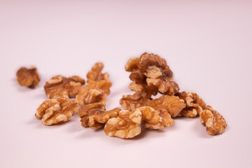 Several kernels of walnuts are on a white surface