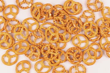 Scattered salty crackers on top on a white surface