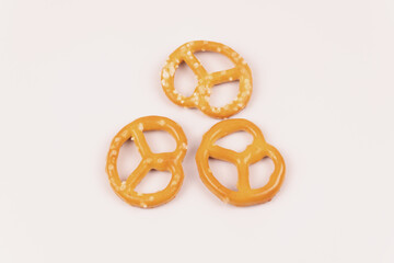 Three dry salty crackers lie on a white background