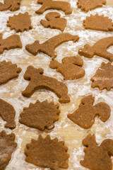 Christmas background with gingerbread cookies. Animal-shaped cookies cut from gingerbread dough.