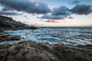 waves breaking on stone reef atlantic ocean on Tenerife island, ocean in motion on Canary islands, Spain.