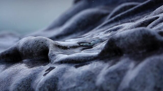 Closeup of raindrops falling on stones, rainy season, fixed shot