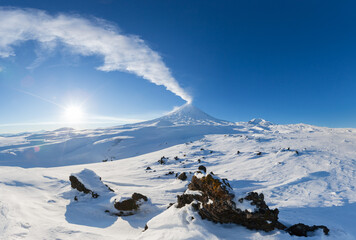 Kamchatka Peninsula, winter mountain landscape, beautiful panoramic view of eruption active volcano in clear sunny weather with blue sky. Klyuchevskoy Volcano, Klyuchevskaya Group of Volcanoes, Russia © Alexander Piragis