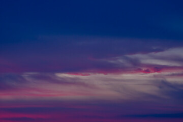 dark blue sky with clouds defocused background