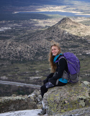 young blonde girl enjoying in the mountains