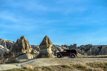 Tourists discover the beautiful Fairy Chimney formations in Cappadocia by off-road vehicles. 4x4 car safari © attraction art