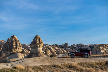Tourists discover the beautiful Fairy Chimney formations in Cappadocia by off-road vehicles. 4x4 car safari © attraction art