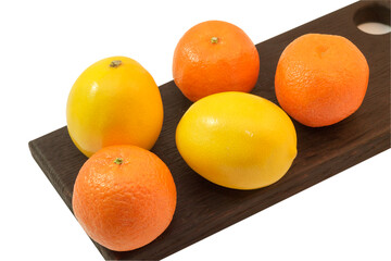 Fresh fruits tangerines and lemons on a cutting wooden board, isolate on a white background.