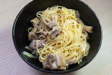 A bowl of pork belly pasta.