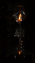 Tea light candle inside wine glass 