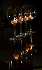 Tea light candle inside wine glass 