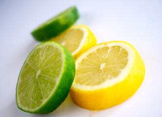 lemon and lime slices on white background