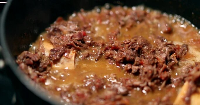 Cooking osso buco meet inside pan. braised veal food close-up