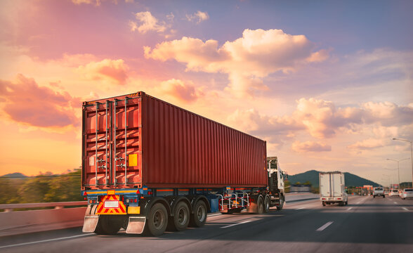 Truck with red container on the highway with sunset time, logistic import export and transport industry concept