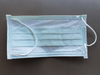 A mask that is placed upside down for a clear view of the harness section. Wearing a mask and washing your hands with gel is essential during the COVID-19 epidemic.
