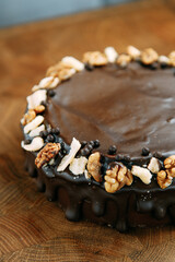 Chocolate cake made of loose dough on a wooden table. Sliced cake with caramel filling.