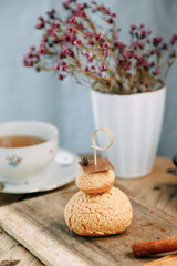Custard cake with chocolate and berry filling. Round cake with mousse cream on a wooden table.