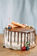 Sweet cake with fresh berries on a wooden background. Cake with delicate cream and fruit close-up.