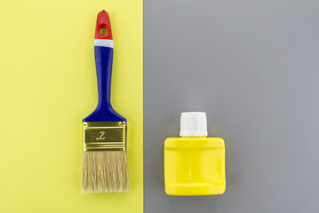 Paintbrush on two tone grey and yellow background