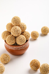 Indian sweet for traditional festival makar sankranti :Rajgira laddu made from Amaranth seed in Bowl on white background