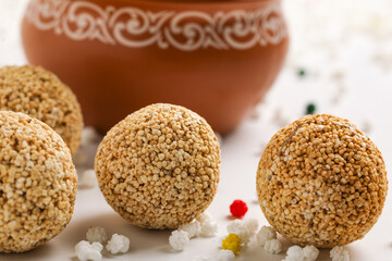 Obraz na płótnie Canvas Indian sweet for traditional festival makar sankranti :Rajgira laddu made from Amaranth seed in Bowl on white background