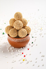 Indian sweet for traditional festival makar sankranti :Rajgira laddu made from Amaranth seed in Bowl on white background