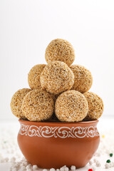 Indian sweet for traditional festival makar sankranti :Rajgira laddu made from Amaranth seed in Bowl on white background