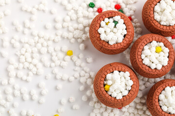 Indian festival makar sankranti concept : Tilgul in small bowl. Tilgul is a colourful sesame candy coated with sesame seeds; in Maharashtra people exchange tilgul on Sankranti