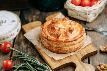 Pie with chicken and mushrooms from puff pastry. Pies cut in half close-up.