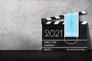 2021 text title on film slate and surgical mask.COVID-19,Coronavirus movie concept.