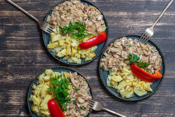 Roasted wild porcini mushrooms and fried potatoes on plate, top view. Ukraine
