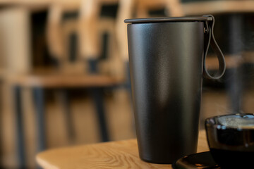 Hot coffee in cup for take away at coffee shop. Selective focus and free space for text. Coffee for take home in cafe, Protection form Virus Corona 19 ideas concept.