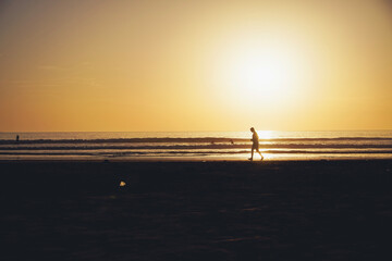 Surfers during sunset in Taghazout, Morocco