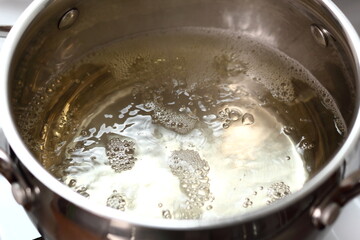 Fototapeta na wymiar Boiling sparkling wine in saucepan