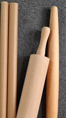 Rolling pins and baking parchment on granite table. Directly Above.