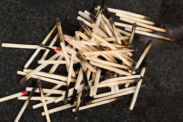 Heap of burnt matches on granite table