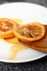 Fototapeta na wymiar Candied in Treacle Syrup Lemon Slices on plate