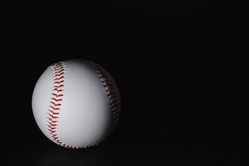 American traditional sports game. Baseball. Concept. Baseball ball and bats on a black table.