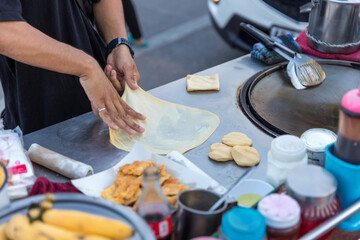 Fototapeta na wymiar Roti Making, roti thresh flour by roti maker with oil. Indian traditional street food. Thai Pancake Banana And Egg . Thai Street Food and Desserts. Making of roti snack