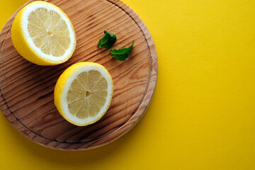 Lemon cut in half on a yellow background