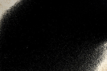 Pile desert sand isolated on black. Dust heap beach texture on shore background. Tranquil beach scene with copy space.