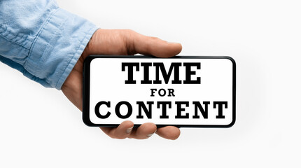 Closeup of a male hand holding Smartphone with text Time For Content on display