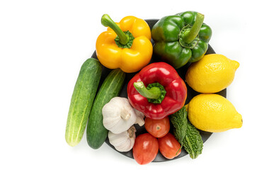Fototapeta na wymiar fresh fruits and vegetables in black plate. organic food. vegan food concept. Healthy diet eating for immune boosting. Top view.