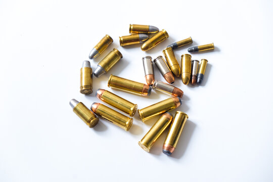Group of pistol bullet .44 magnum 9mm and .45 on white background